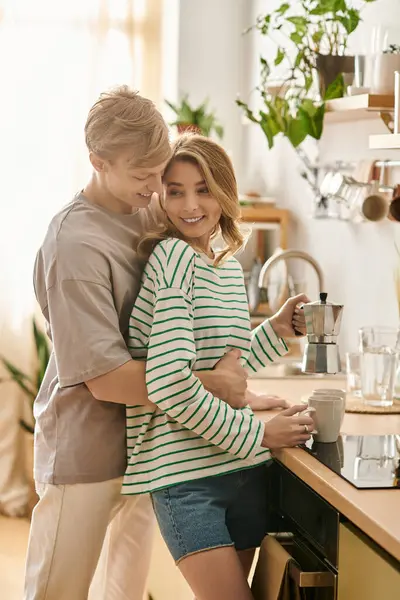 A young couple shares love and happiness in their cozy kitchen over coffee. — Stock Photo