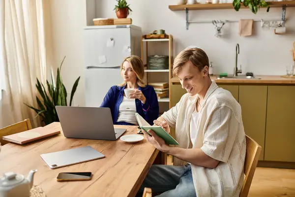 A young couple relaxes in their stylish home, engaging in work and enjoying each others company. — Stock Photo