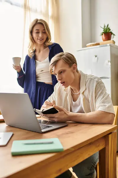 Young couple engages in a delightful day at home, balancing work and sweet moments together. — Stock Photo