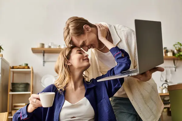Loving couple embraces in a stylish home, sharing smiles and warmth over a coffee moment. — Stock Photo