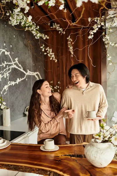 In a warm setting, a couple laughs together, prepping for their wedding among lovely flowers. — Stock Photo