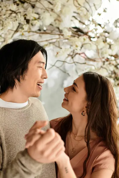 A couple shares a heartfelt moment while surrounded by beautiful blooms for their wedding. — Stock Photo