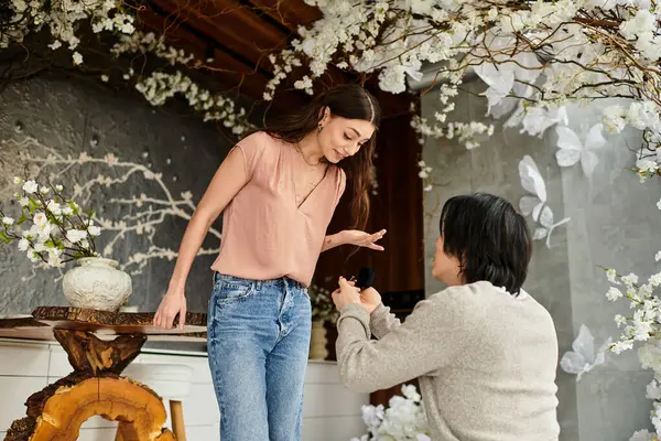 Man proposes to his partner in a vibrant setting, surrounded by beautiful floral decorations. — Stock Photo