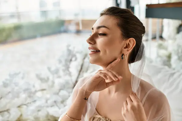 A beautiful young bride smiles gently while preparing for her wedding day in an exquisite setting. — Stock Photo