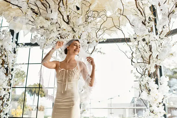 The beautiful bride glows with happiness in a floral filled venue as she preps for her big day. — Stock Photo