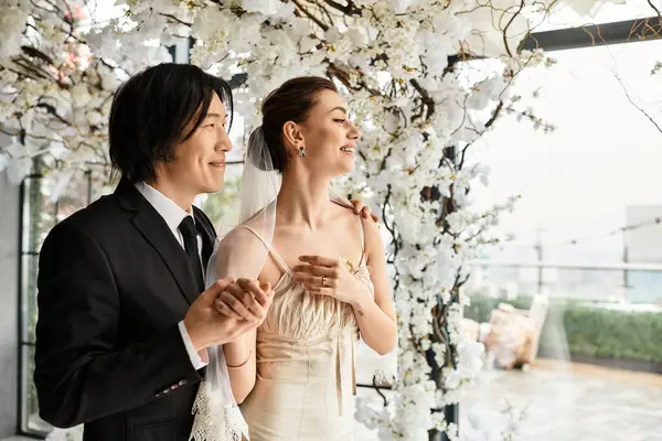 Charming bride and groom smile lovingly at each other during their enchanting wedding celebration. — Stock Photo