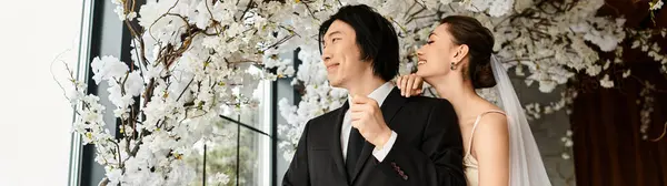 A loving couple shares a tender moment surrounded by elegant flowers, radiating romance. — Stock Photo