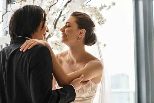 A loving couple shares a tender moment during their wedding ceremony, embracing their commitment. — Stock Photo