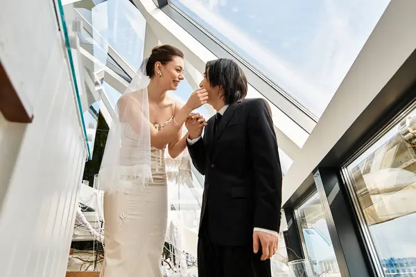 Loving couple exchanges tender smiles and laughter in an elegant wedding setting filled with joy. — Stock Photo