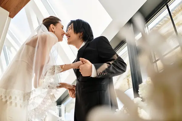 A young couple embracing joyfully in a romantic atmosphere, immersed in their wedding celebration. — Stock Photo