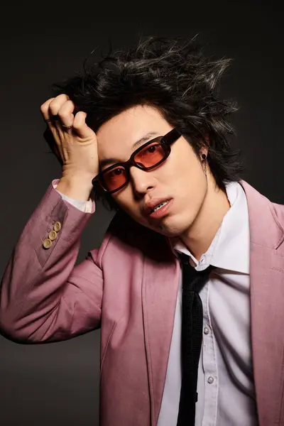 An asian man with blood on face showcases trendy spring fashion, highlighting his unique style in a studio. — Stock Photo