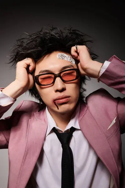 Asian man with blood on face poses confidently in a spring-themed studio. — Stock Photo