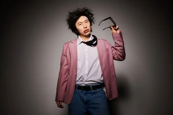 An asian man with blood on face showcases trendy clothing with a confident expression in a studio during spring. — Stock Photo