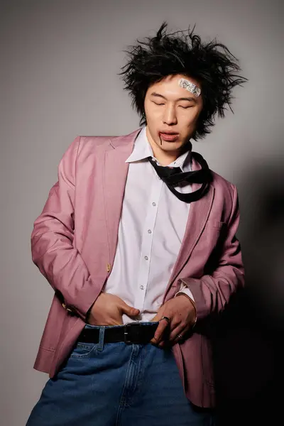 A fashionable Asian man with blood on face showcases vibrant spring attire in a unique studio environment. — Stock Photo