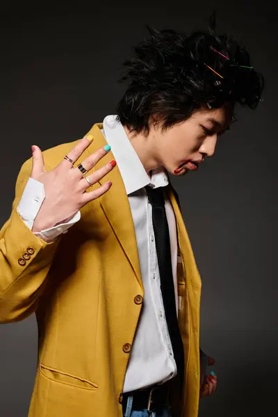 Asian man with blood on face dressed in trendy clothing exudes confidence in a stylish studio setting. — Stock Photo