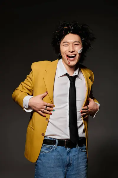 An Asian man with blood on face confidently displays his unique fashion sense in a studio — Stock Photo