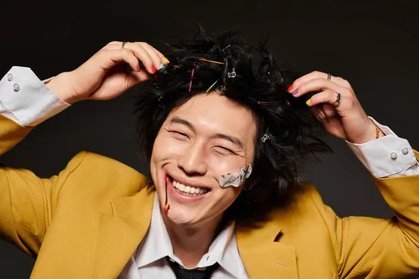 Asian man with blood on face showcases bold spring fashion in a studio, with smile — Stock Photo