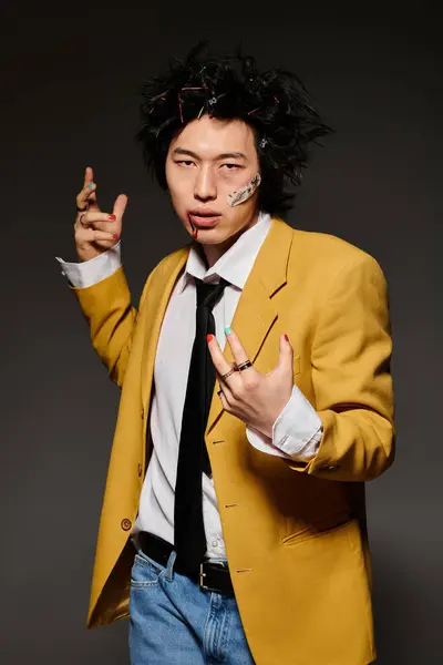 An asian man with blood on face showcases his unique spring fashion style with confidence in a chic studio. — Stock Photo