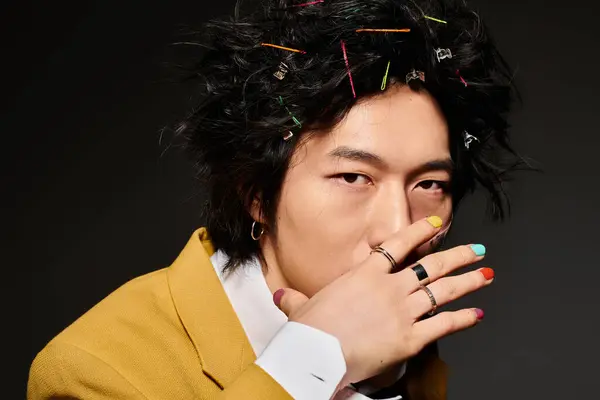 An asian man expresses creativity in fashionable spring attire, presenting a unique style. — Stock Photo