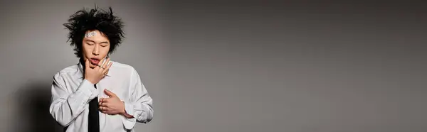An Asian man with blood on face feeling hurt in studio, banner — Stock Photo