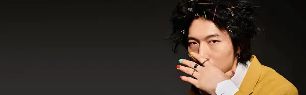 An Asian man models trendy spring attire in a stylish studio environment, expressing creativity, banner — Stock Photo