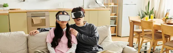 A young asian couple relaxes together at home, exploring virtual reality adventures, banner — Stock Photo