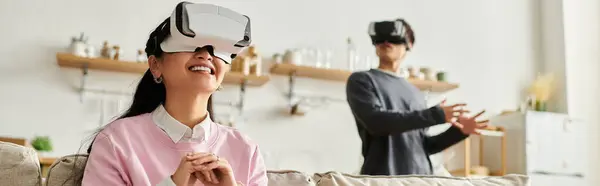 Couple engages with virtual reality technology, sharing laughter and excitement indoors, banner — Stock Photo