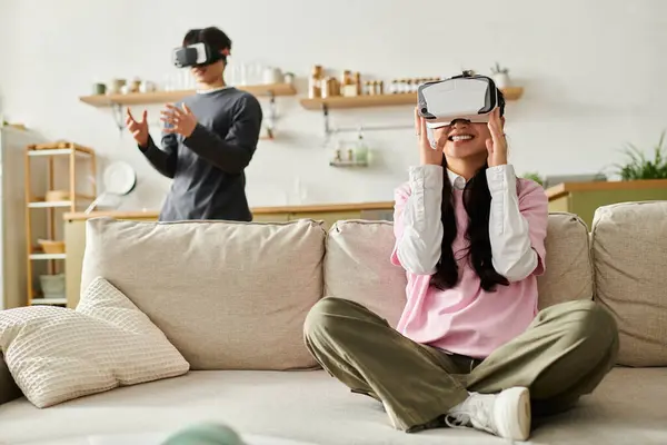 A young couple explores immersive virtual worlds while relaxing at home. — Stock Photo