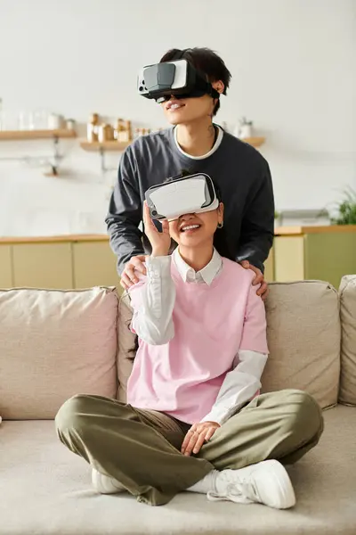 Young couple engages in a fun virtual reality session at home, sharing laughter and excitement. — Stock Photo