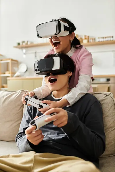 Young couple enjoys an immersive gaming experience while laughing together at home. — Stock Photo