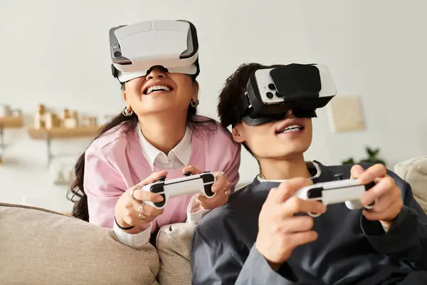 A young couple shares laughter and excitement while using virtual reality headsets and controllers. — Stock Photo