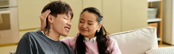 A young couple enjoys a tender moment together on the couch, radiating warmth and connection, banner — Stock Photo