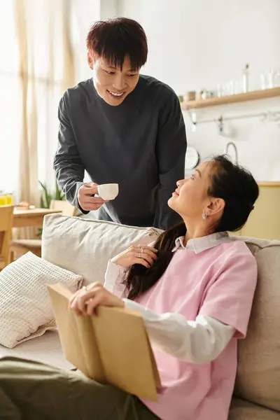A young couple enjoys a cozy moment together at home, cherishing each other's company. — Stock Photo