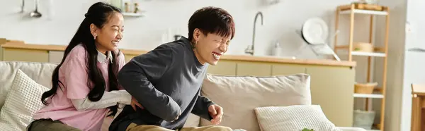 Young couple shares laughter and playful affection while relaxing at home together, banner — Stock Photo
