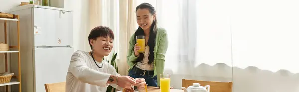 A young couple shares a delightful breakfast while sipping refreshing drinks at home, banner — Stock Photo
