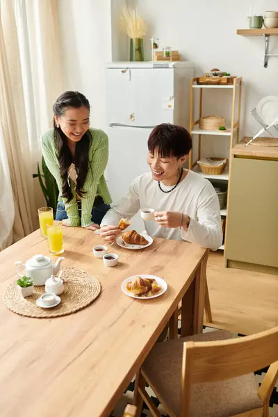 Joyful moments unfold as a young couple enjoys a delightful breakfast together at home. — Stock Photo