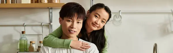 A young Asian couple enjoys a warm breakfast together at home, smiling and happy, banner — Stock Photo