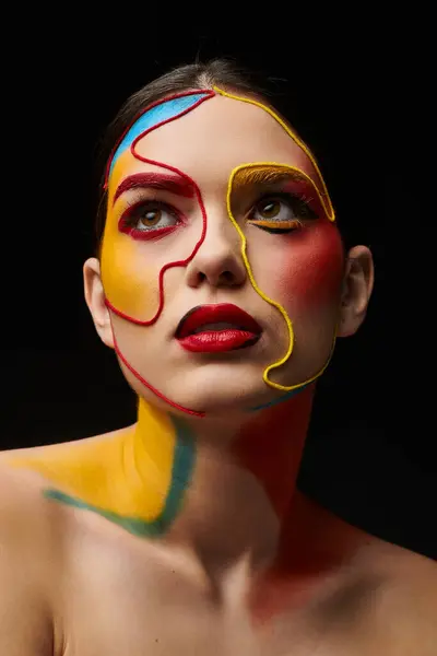 A young woman displays vibrant face art that highlights her features beautifully. — Stock Photo