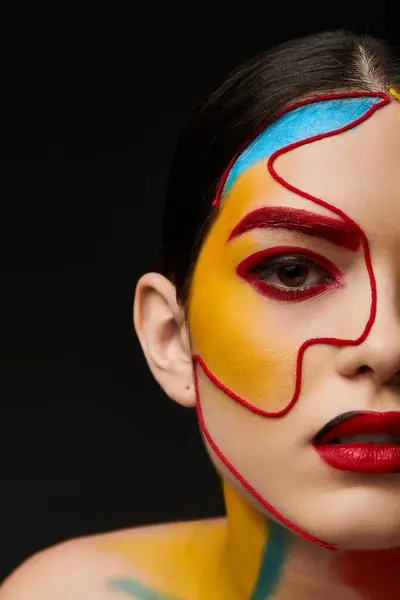 A young beautiful woman showcases vibrant face art that enhances her features with playful colors. — Stock Photo