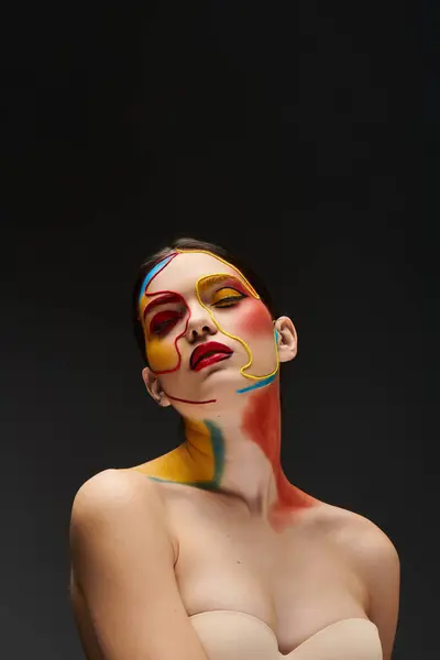 Young woman showcases colorful face art with artistic designs in a modern atmosphere. — Stock Photo