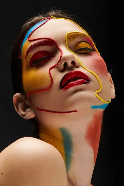 A young woman displays vibrant face art, showcasing her beauty and style with colorful paint. — Stock Photo
