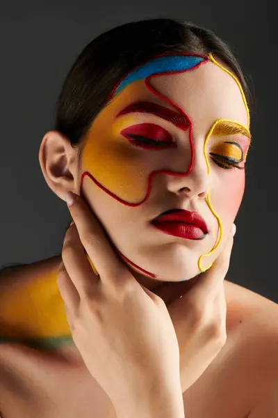 Young woman with vibrant face art showcases a unique mix of colors and patterns elegantly. — Stock Photo