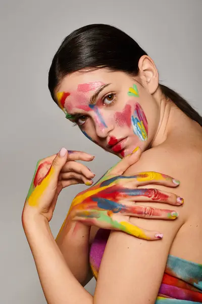 A young woman displays vibrant face art, celebrating creativity and self expression. — Stock Photo