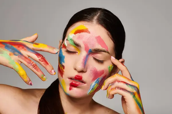 A young woman showcases her artistic side with bold face paint, expressing vibrant creativity. — Stock Photo