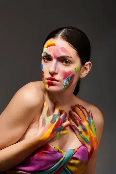 A young woman displays vibrant face art, celebrating creativity and style. — Stock Photo