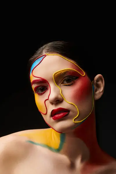 A young beautiful woman displays vibrant face art with intricate paint designs, exuding creativity. — Stock Photo