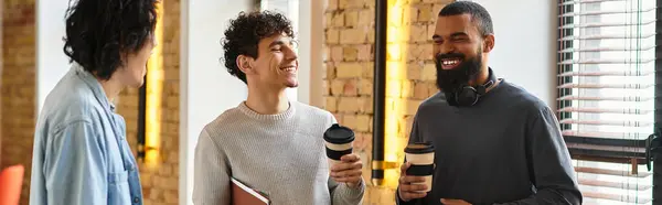 Three colleagues enjoy a joyful moment discussing ideas over coffee in a stylish office space. — Stock Photo