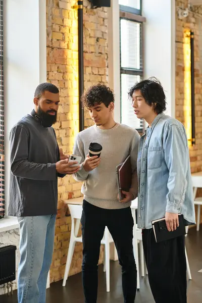 Three professionals discuss and review documents together thoughtfully. — Stock Photo