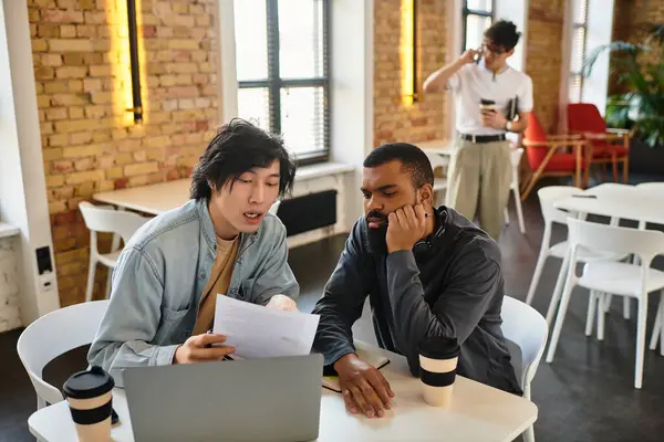 Two professionals engage in a collaborative effort while examining documents together. — Stock Photo