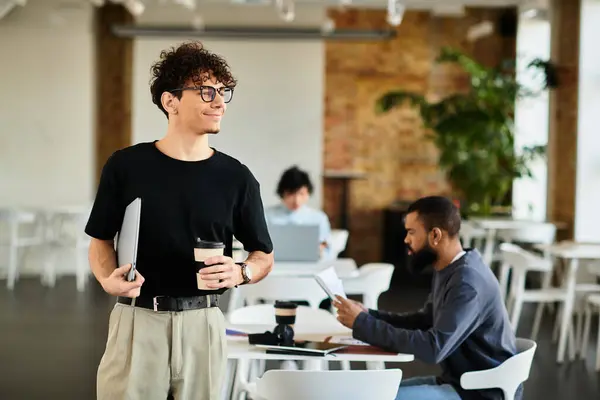 Professionals engage in focused tasks within a stylish office environment while sharing ideas. — Stock Photo